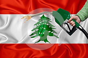 LEBANON flag Close-up shot on waving background texture with Fuel pump nozzle in hand. The concept of design solutions. 3d