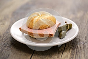 LeberkÃ¤ssemmel is a Kaiser roll sandwich with LeberkÃ¤se meatloaf in between. photo
