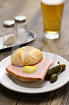 LeberkÃ¤ssemmel is a Kaiser roll sandwich with LeberkÃ¤se meatloaf in between. photo