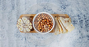 Leblebi Turkish delicacy of fried chickpeas, garlic and tortillas on compartmental dish, long format banner, selective focus photo