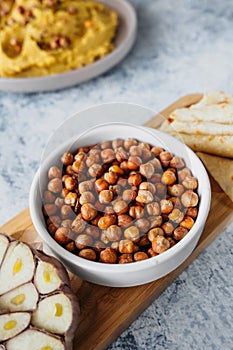 Leblebi Turkish delicacy of fried chickpeas, garlic and tortillas on compartmental dish, vertical food content, selective focus photo