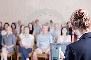 Lecturer giving speech during conference photo