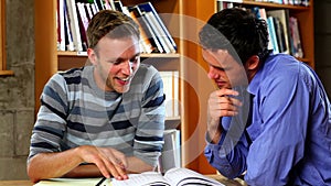 Lecturer helping young student in the library