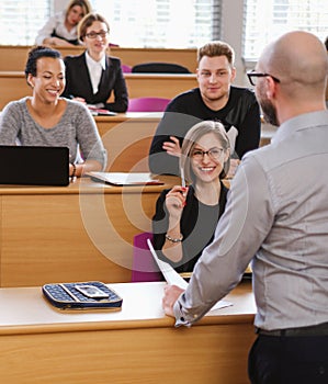 Lecturer and multinational group of students in an auditorium