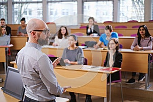 Lecturer and multinational group of students in an auditorium