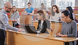 Lecturer and multinational group of students in an auditorium