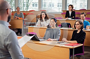 Lecturer and multinational group of students in an auditorium