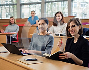 Lecturer and multinational group of students in an auditorium photo