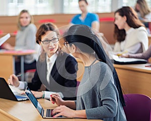 Lecturer and multinational group of students in an auditorium