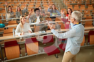 Lecturer in university - students listening to teacher in the classroom on college