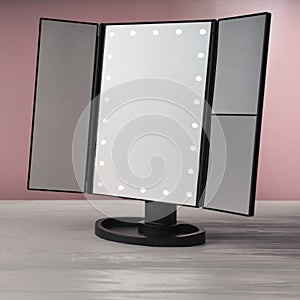 LED black vanity make up mirror on white wooden table and pink background