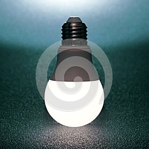 Led bulb included on a dark background. everyday household item in electricity