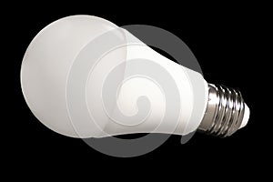 Led bulb light and energy-saving lamp on table on black background