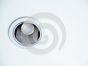 LED ceiling light. Downlight with light bulb on white ceiling background photo