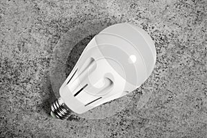 LED energy-saving lamp with E27 screw cap base on gray background