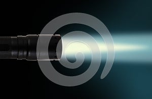 LED flashlight beam on black background