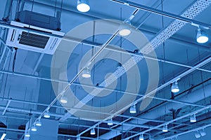 LED floodlights suspended from the ceiling on rails. lighting system in a shopping center, warehouse or office. Ceiling