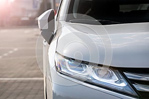 Led headlight of a white modern car. Modern trends in the automotive industry. Head optics of the machine