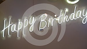 LED inscription Happy Birthday on a banner. Slow motion