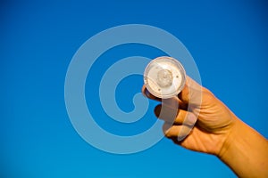 LED lamp in hand against blue sky