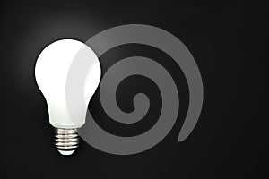 LED light bulb on black background, concept of ideas, creativity, innovation or saving energy, copy space, top view, flat lay