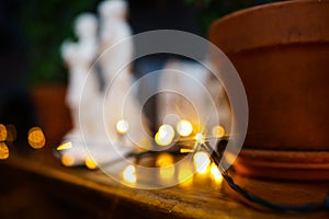 LED light bulb electric garland on the shelf near the pot.