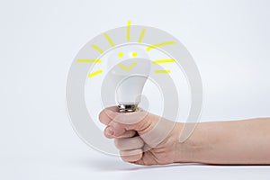 Led light bulb in hand with painted imitation light. The concept of a new idea and a good mood.