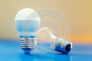 Led light bulb lay next to incandescent bulb