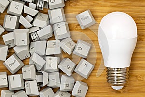 LED light bulb and pile of computer keyboard keys