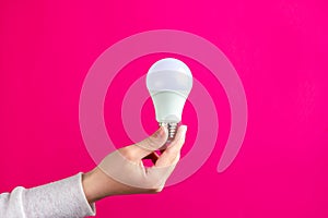 LED light bulb in a woman& x27;s hand. Energy saving lamp.