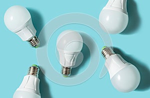 LED light bulbs on blue color background. Flat lay. Pattern.