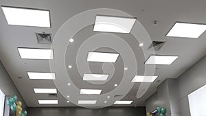 Led panel lamp on modern office ceiling photo
