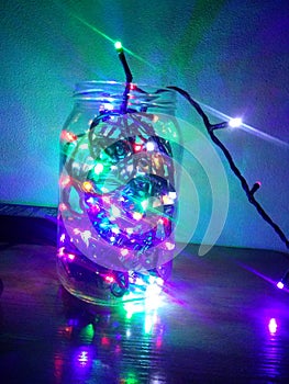 LED lights in a glass jar. agleam Lamp. photo