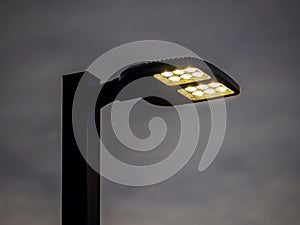 LED street light against a dark overcast sky.