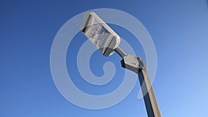 Led streetlight on high metal pole under clear blue sky