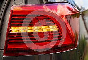 LED turn signal in the rear brake light of the car. Modern car lantern, close-up