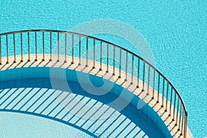 Ledge with railing separating pools