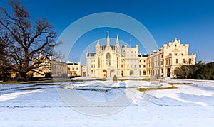 The Lednice castle panorama in snow, winter. Beautiful old historical architecture, blue sky. Czech republic unesco