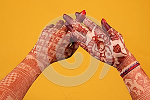 Ledy Feet and Hands in Heena for wedding in Orange and red background and isolated hand and feet