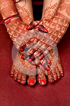 Ledy Feet and Hands in Heena for wedding in Orange and red background and isolated hand and feet