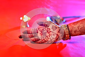 Ledy Feet and Hands in Heena for wedding in Orange and red background and isolated hand and feet