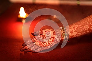 Ledy Feet and Hands in Heena for wedding in Orange and red background and isolated hand and feet