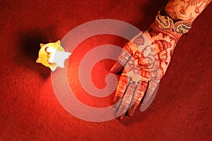 Ledy Feet and Hands in Heena for wedding in Orange and red background and isolated hand and feet