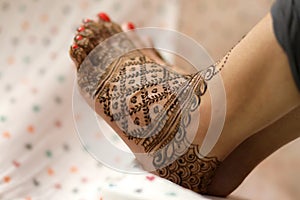 Ledy Feet and Hands in Heena for wedding in Orange and red background and isolated hand and feet