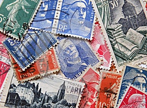 A loose assortment of old french postage stamps form the 1950s and 6os with various different desi