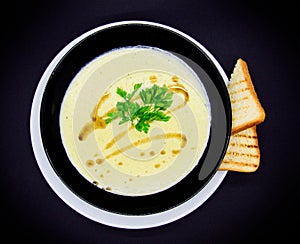 Leek cream soup on black background