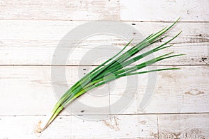 Leek, large bunch of green onions on board, food, Close up chopped fresh spring onion on rustic wood table in top view flat lay