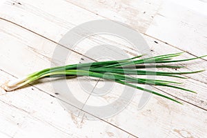 Leek, large bunch of green onions on board, food, Close up chopped fresh spring onion on rustic wood table in top view flat lay