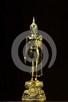 Leela Buddha image, skin covered with real gold and black background.