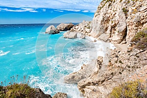 Lefkada Island cliffs with rough sea and clear bluew waves photo